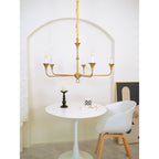 Candle chandelier suspended in an airy interior space
