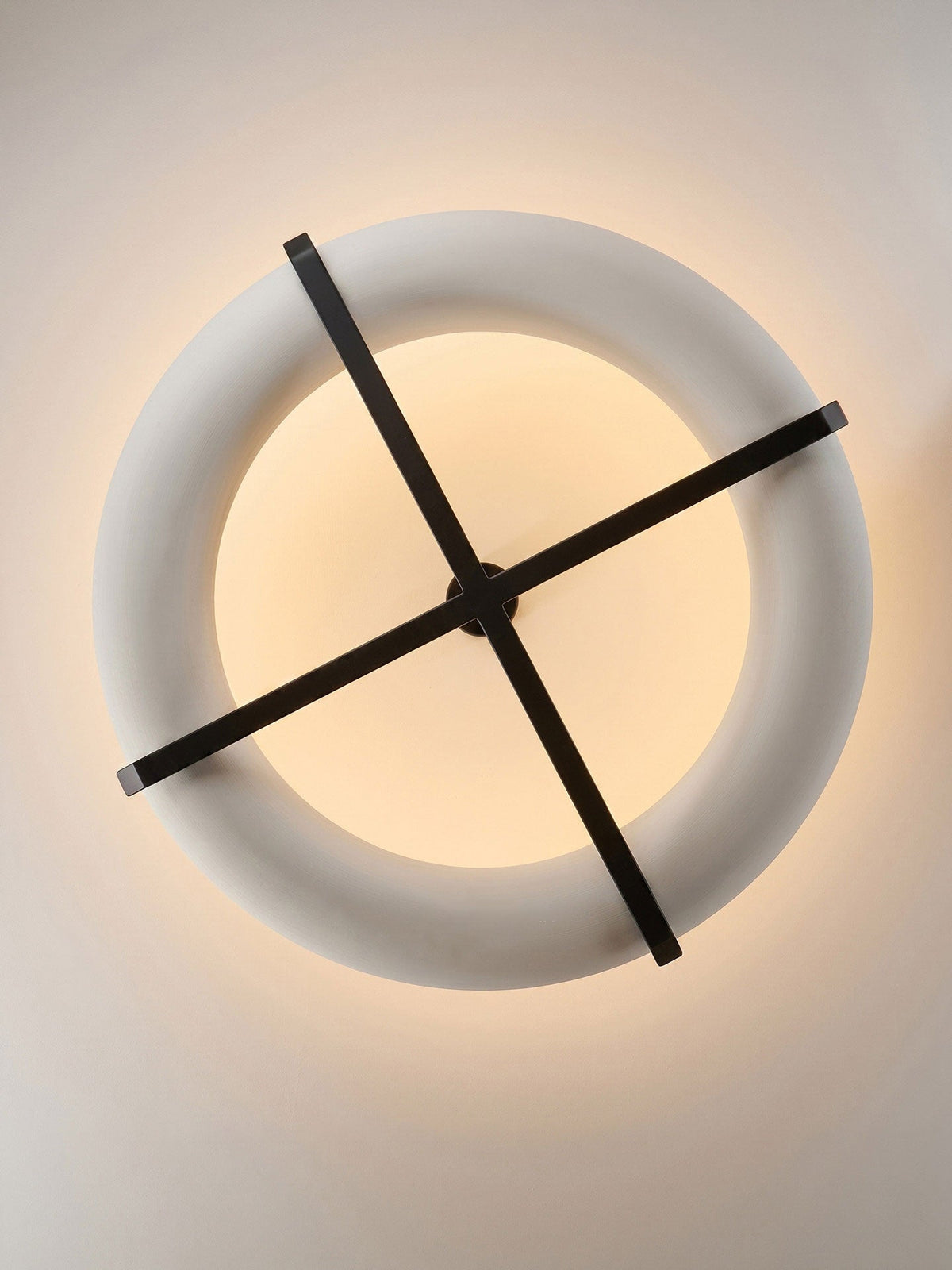 Looking straight up at this Clérachic ceiling light, its full ring shade and crossed black stem fill the frame.