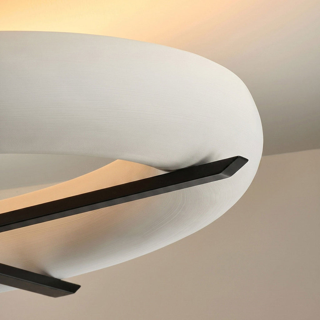 Close view of the crossed black stem on this Clérachic ceiling light, set against its curved white shade.