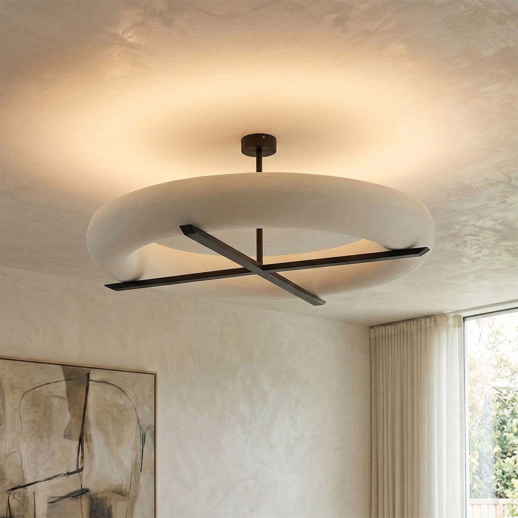 Beside a curtained window and a framed line drawing, this Clérachic ceiling light in black glows on a plaster ceiling.