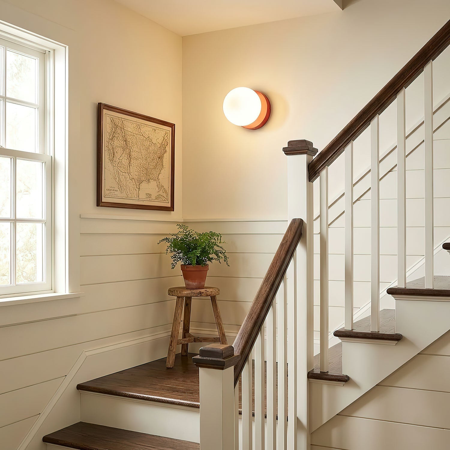 Beige Nuvol wall lamp glowing gently in a cozy corner