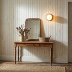 Nuvol wall lamp glowing in a styled minimalist interior