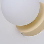 Nuvol glass globe sconce lighting a quiet corner warmly