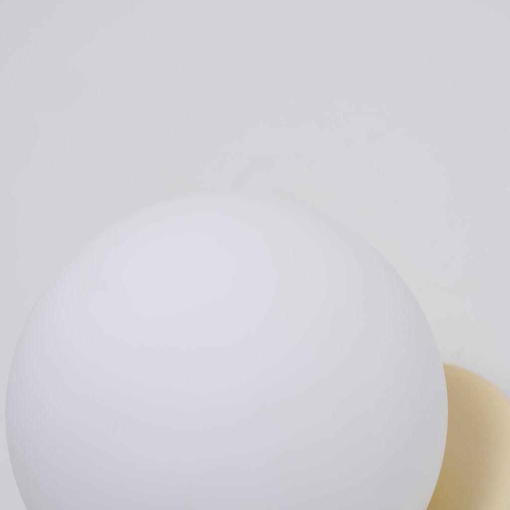 Nuvol wall lamp shown lit in a styled home setting