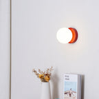 Green Nuvol wall lamp detail showing the metal base and glass globe