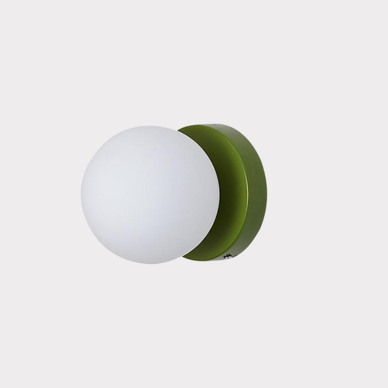 Nuvol compact wall lamp with a white glass globe on a colorful metal base