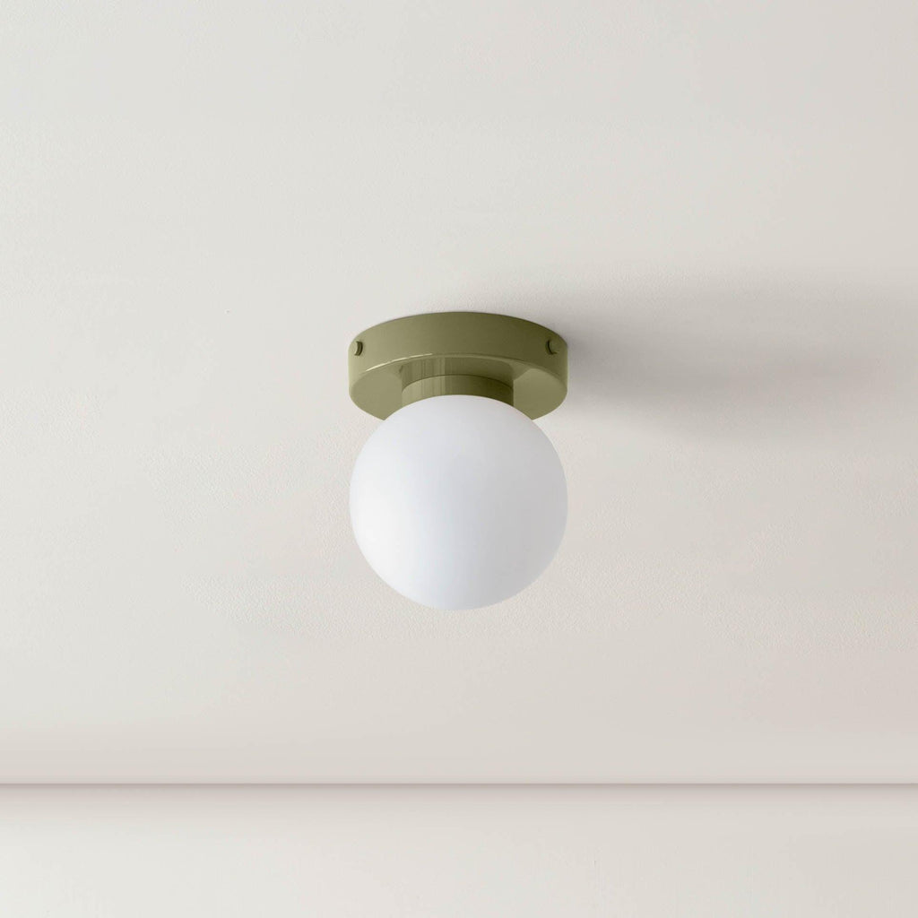 Nuvol compact sconce adding personality to a styled wall
