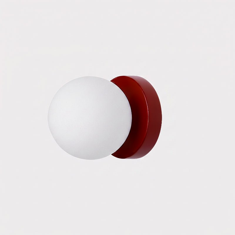 Nuvol wall lamp casting warm diffused light through its glass globe