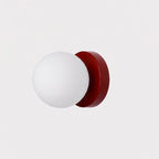 Nuvol wall lamp casting warm diffused light through its glass globe