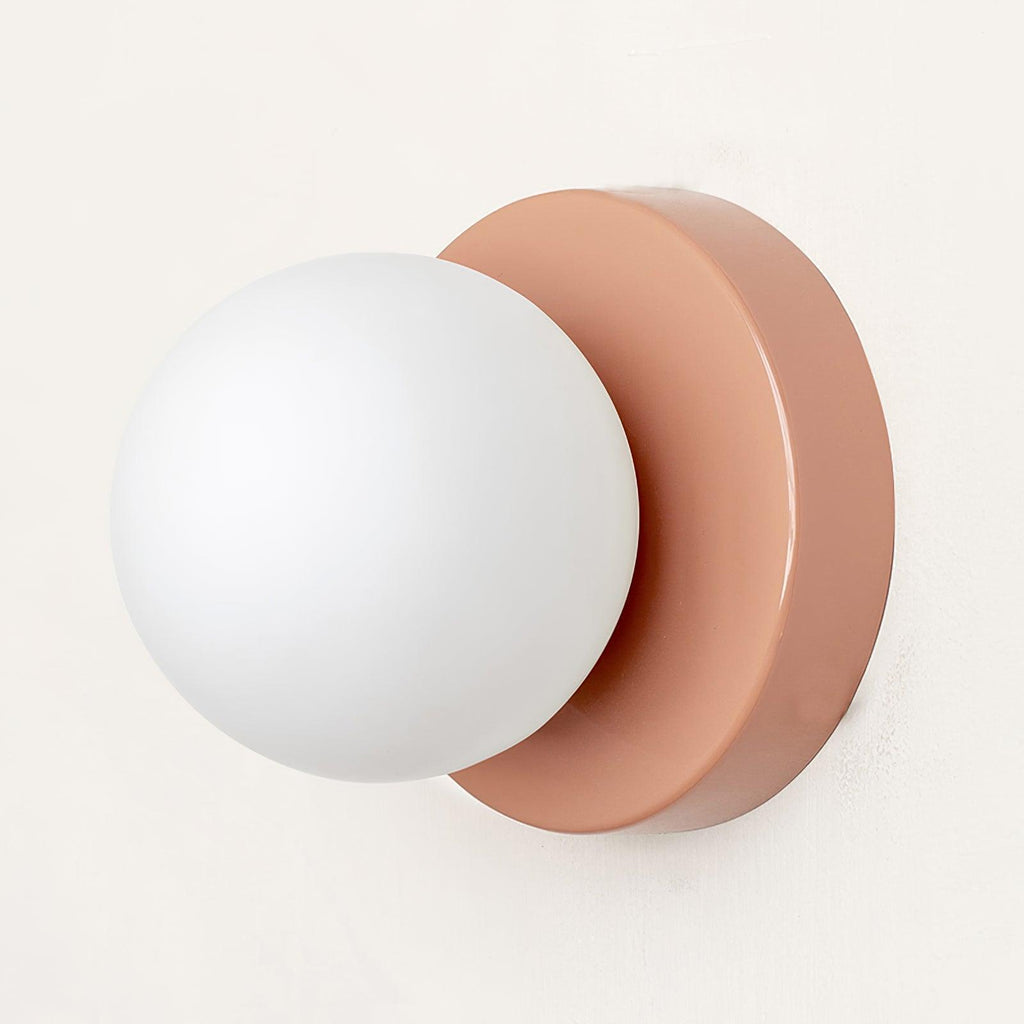 Nuvol wall lamp glowing warmly in a relaxed living space