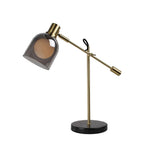 Clérachic brass table lamp on its round black marble base, shown small within a wide plain white frame.