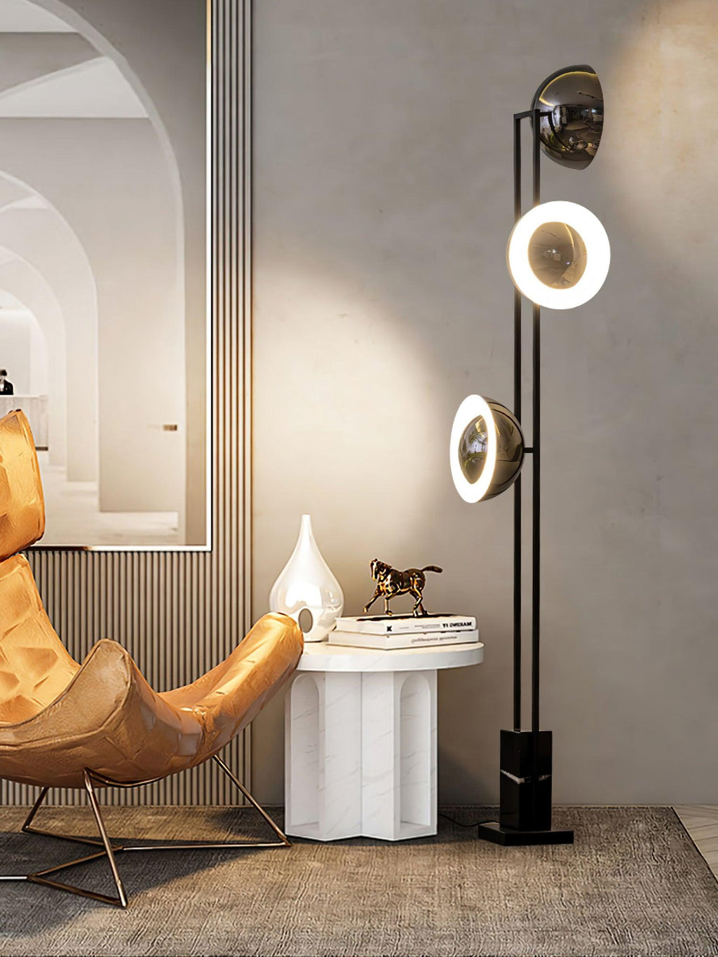 Clérachic floor lamp with its middle ring lit, standing near a gilt mirror, an armchair and a marble side table.