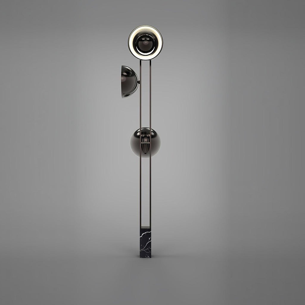 Full-length studio shot of the Clérachic floor lamp on a plain grey backdrop, showing its slim black marble base.