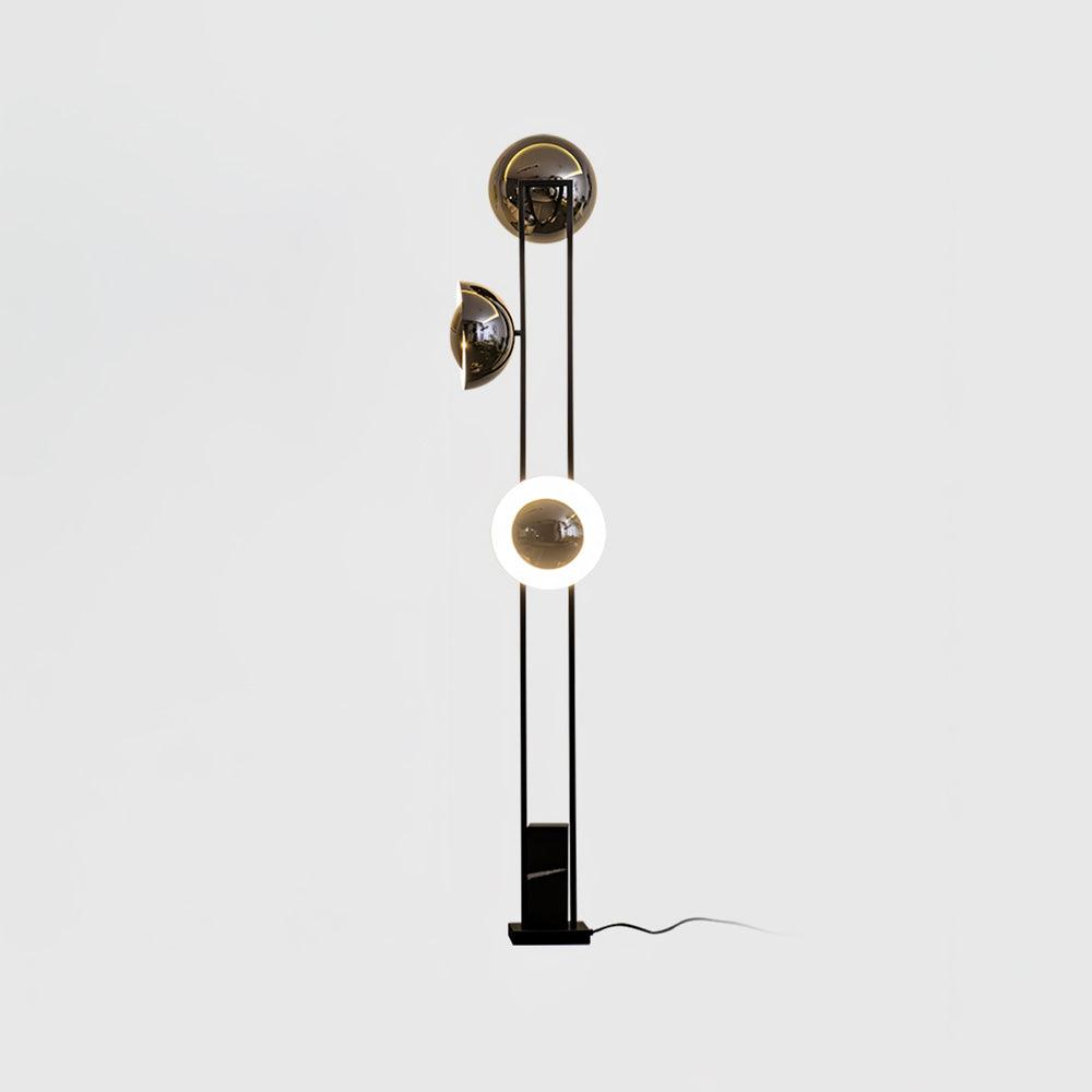 Clérachic floor lamp on a plain studio background, its lower ring lit warm white beneath two dome shades.