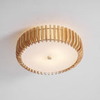 Seen from below in the studio, this Clérachic ceiling light glows lit, slats framing the diffuser.