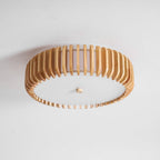 A side-angled studio shot shows this Clérachic ceiling light lit, slats catching the light unevenly.