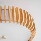 Close view of the slats and small ceiling canopy on this Clérachic ceiling light.