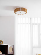 This Clérachic ceiling light sits in a room corner, sheer curtains beside a dark wood cabinet.
