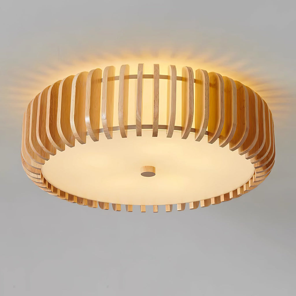 Close underside view of this Clérachic ceiling light lit, warm rays spreading through the wood slats.