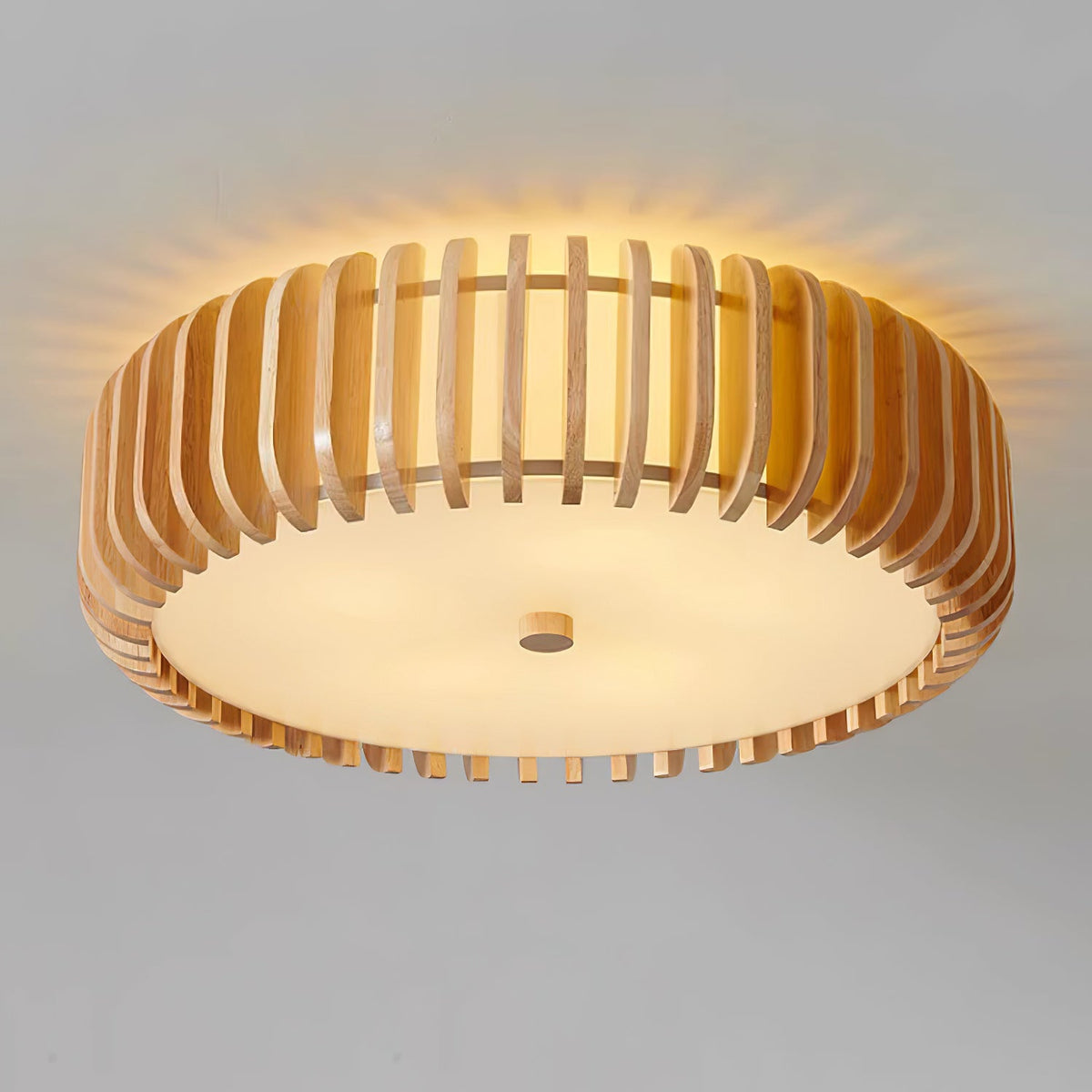 Close underside view of this Clérachic ceiling light lit, warm rays spreading through the wood slats.