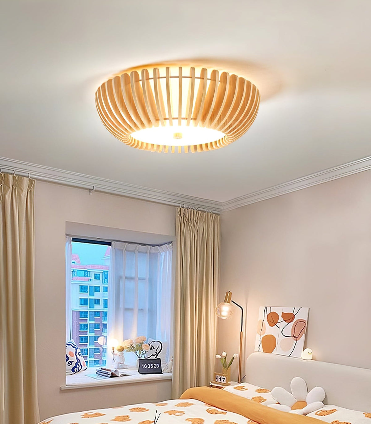 Floral bedding and a city skyline through the window sit below this Clérachic ceiling light, lit.