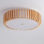 Angled underside studio view of this Clérachic ceiling light, unlit, slats fanning outward.