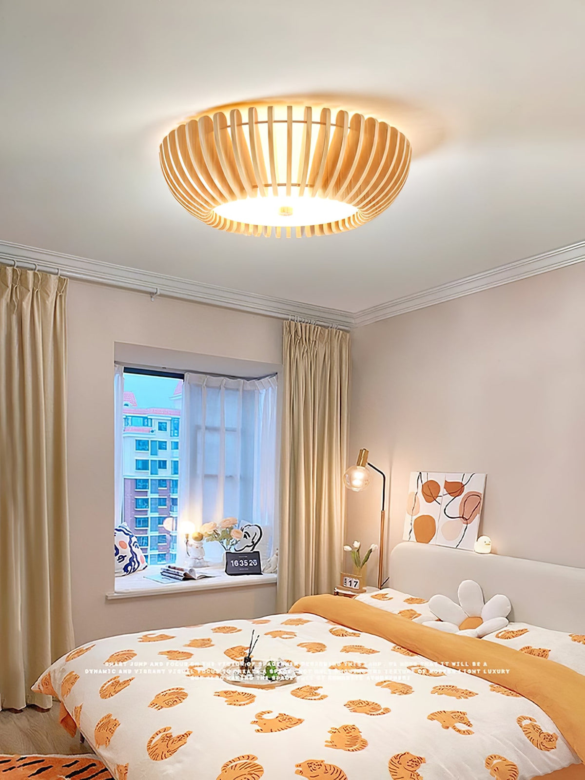 Floral bedding and a curtained window sit below this Clérachic ceiling light, lit, in a bedroom.