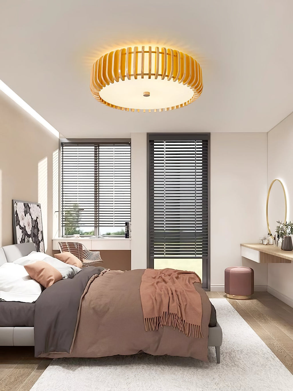A round mirror on a dressing table sits below this Clérachic ceiling light, lit, near the bed.