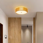 Wood-panelled wardrobe doors line the hallway lit by this Clérachic ceiling light overhead.