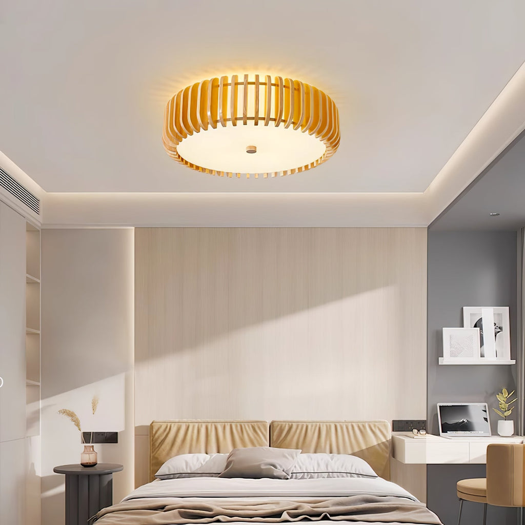 A bedroom with a padded headboard and desk nook, lit by this Clérachic ceiling light overhead.