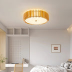 Warm glow from this Clérachic ceiling light over a bed beside open cubby shelving.
