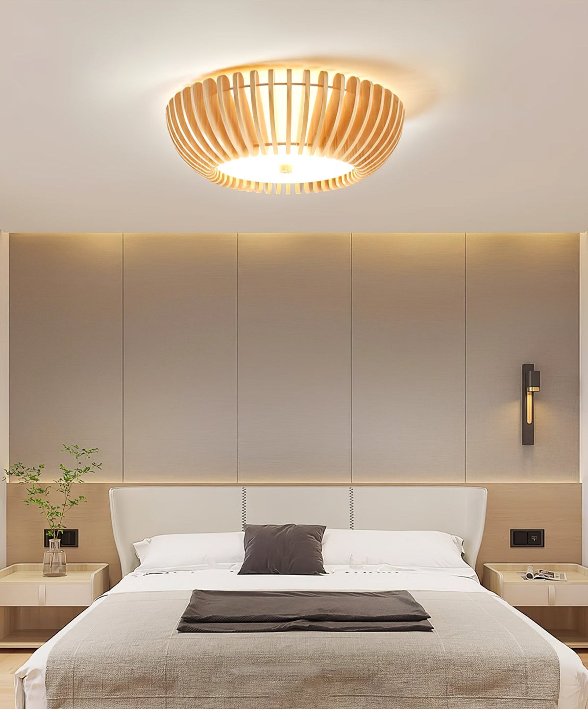 Wall sconces flank the bed below this Clérachic ceiling light, lit, on a dark accent wall.