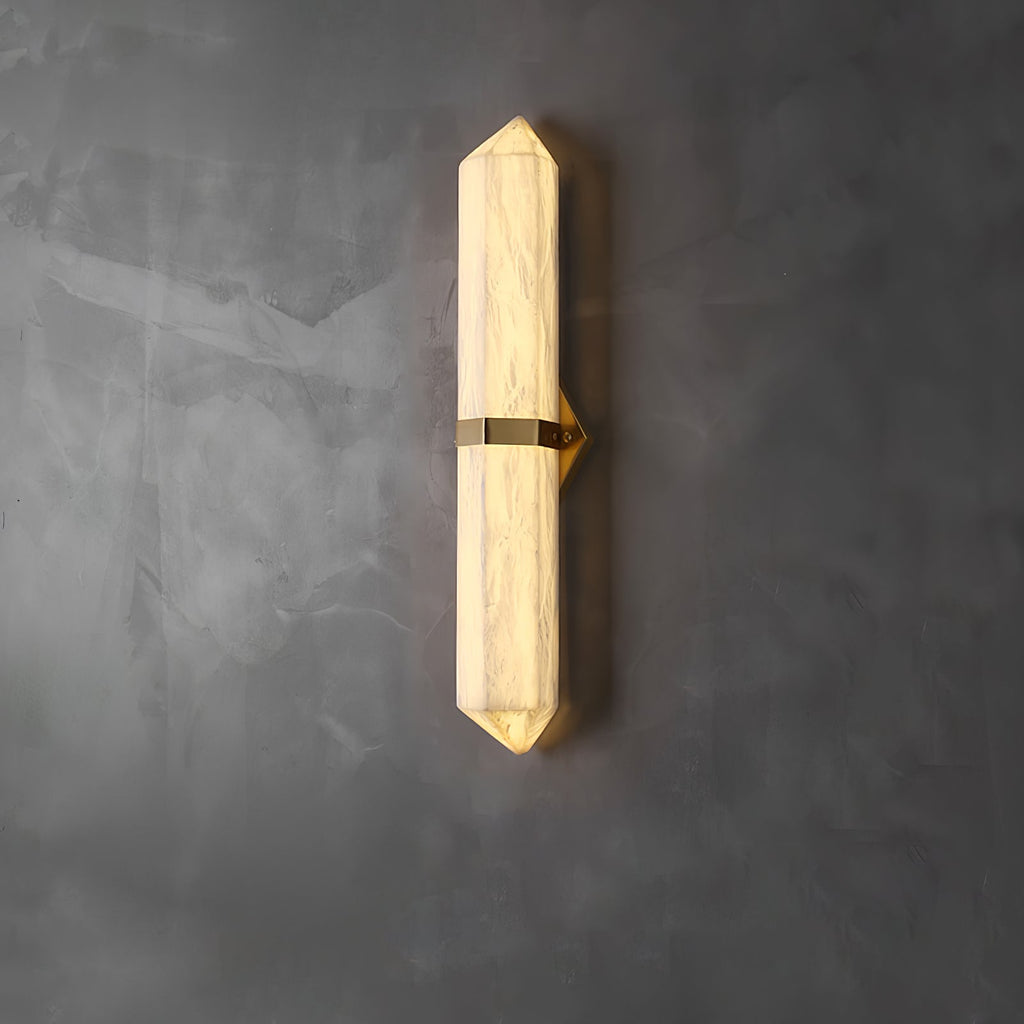 The brass-band version lit on grey concrete, warm light glowing through the faceted stone.