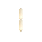 Close view of the brass collar and cord fitting joining the two alabaster shades on the Zovarion pendant.
