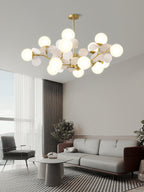 Gold tree chandelier with shades casting a soft warm glow