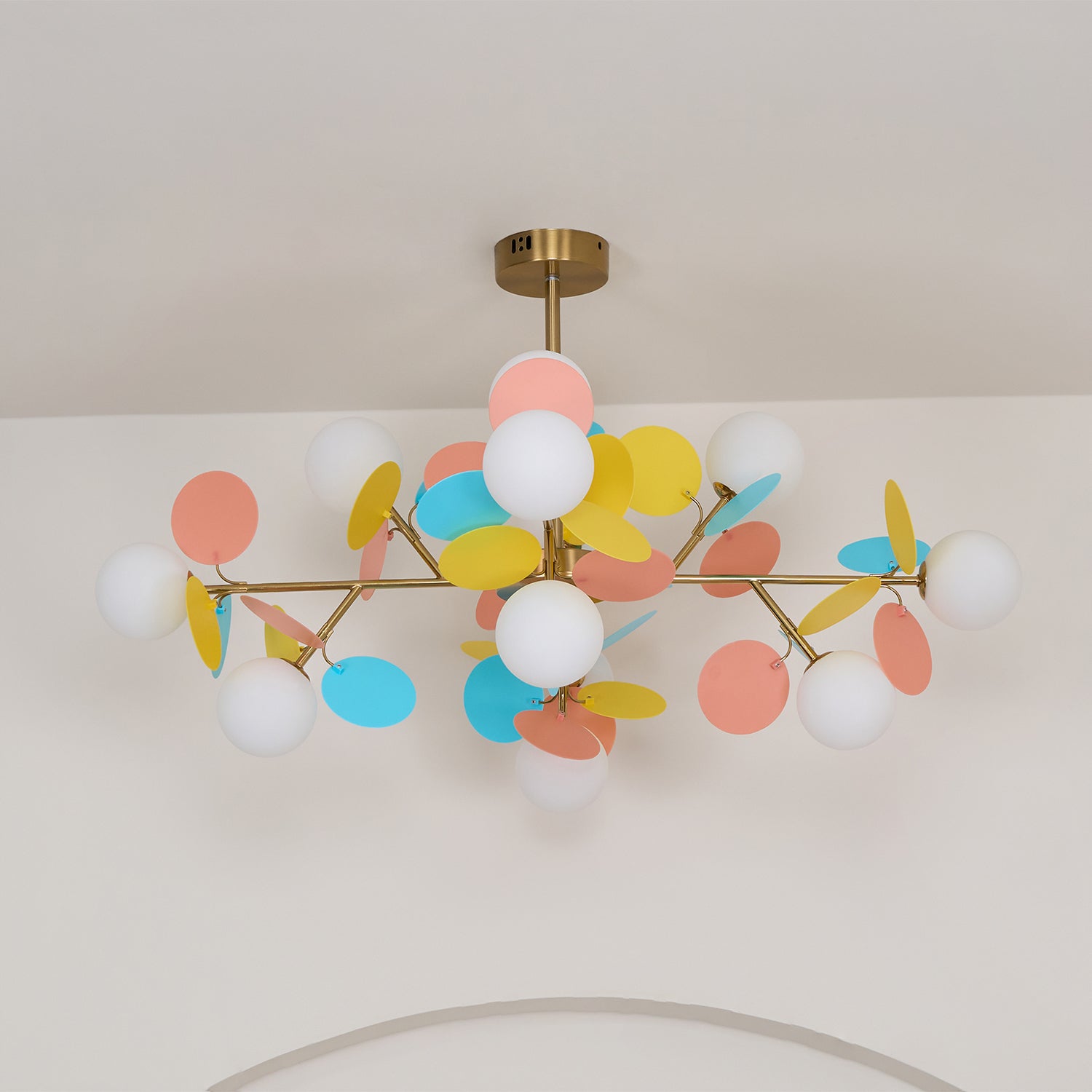 Tree chandelier glowing warmly above a seating arrangement