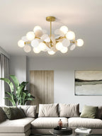 Tree chandelier glowing as the focal point of a neutral room