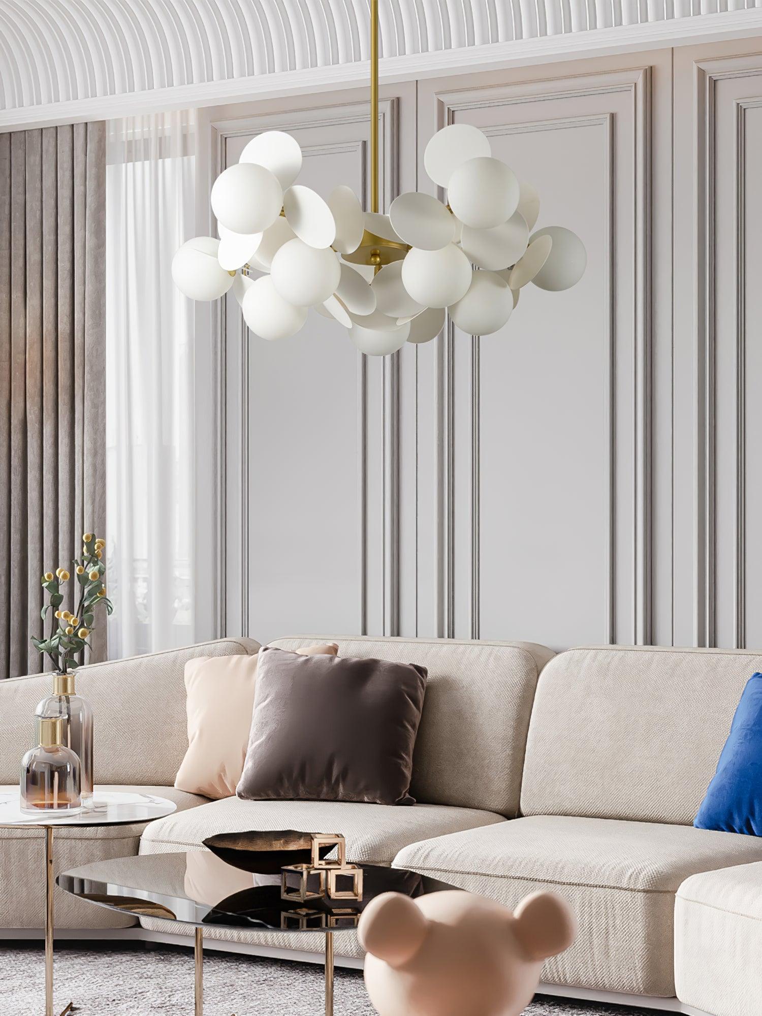 Gold tree chandelier with upward ambient light in an open-plan room