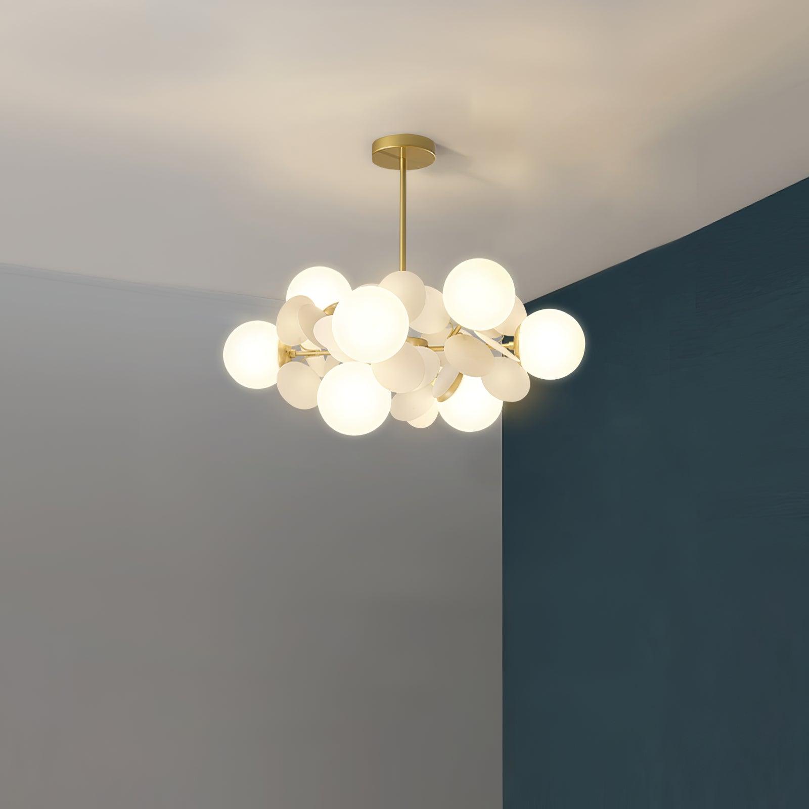 Tree chandelier glass shades reflecting warm light