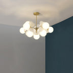 Tree chandelier styled above a dining setting at dusk