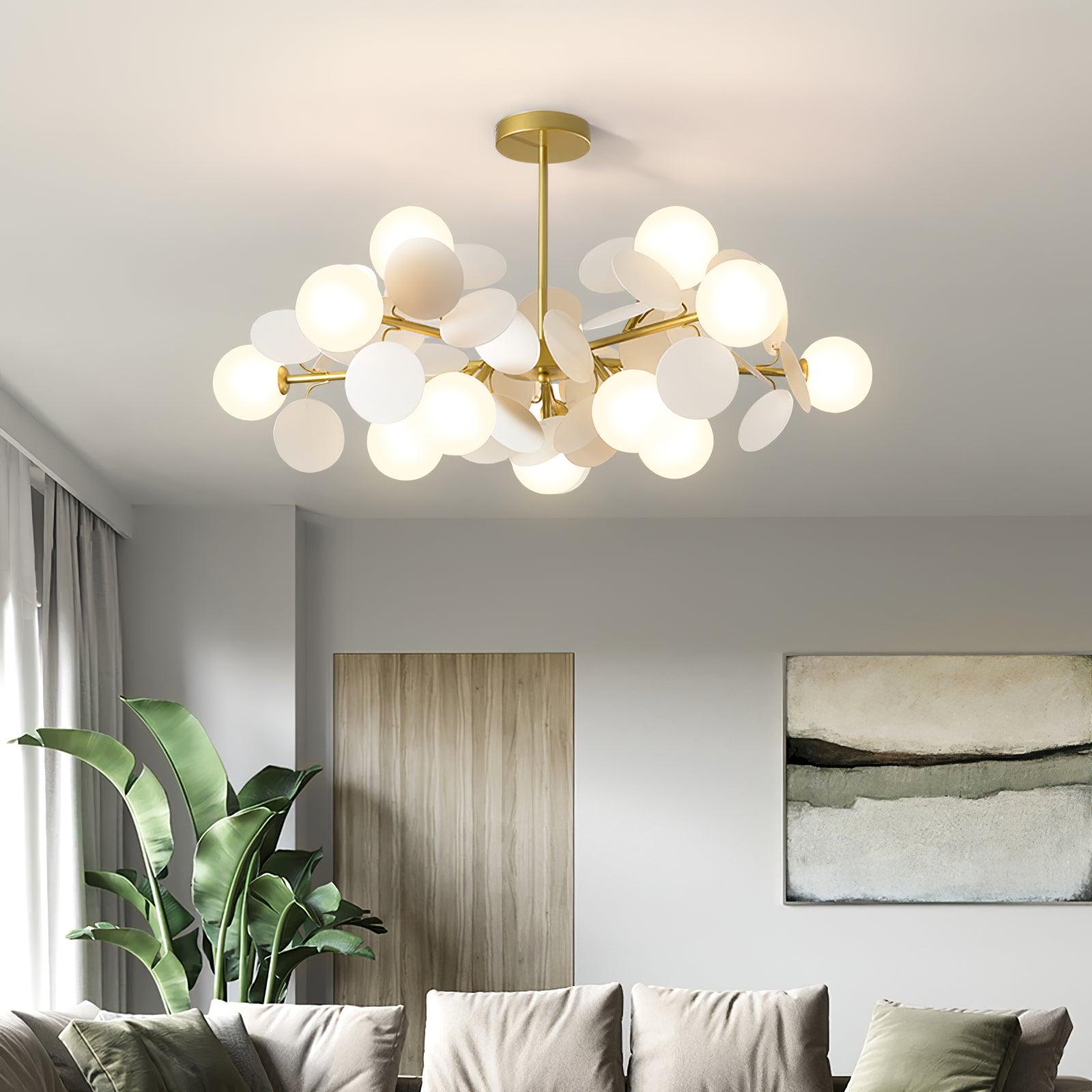Tree chandelier styled over a lounge area with warm glowing shades