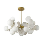 Tree chandelier lit shades glowing warmly across the ceiling