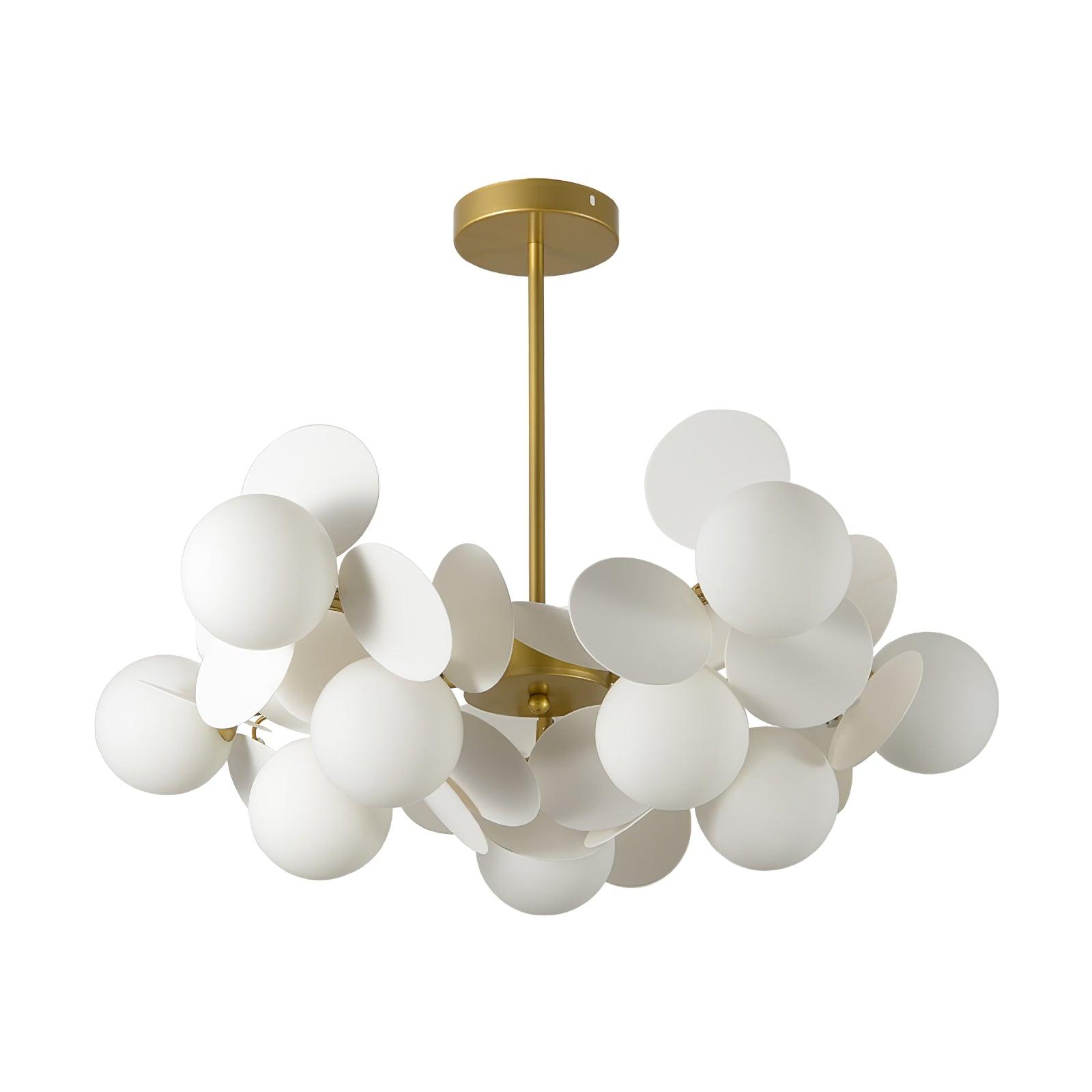 Tree chandelier lit shades glowing warmly across the ceiling