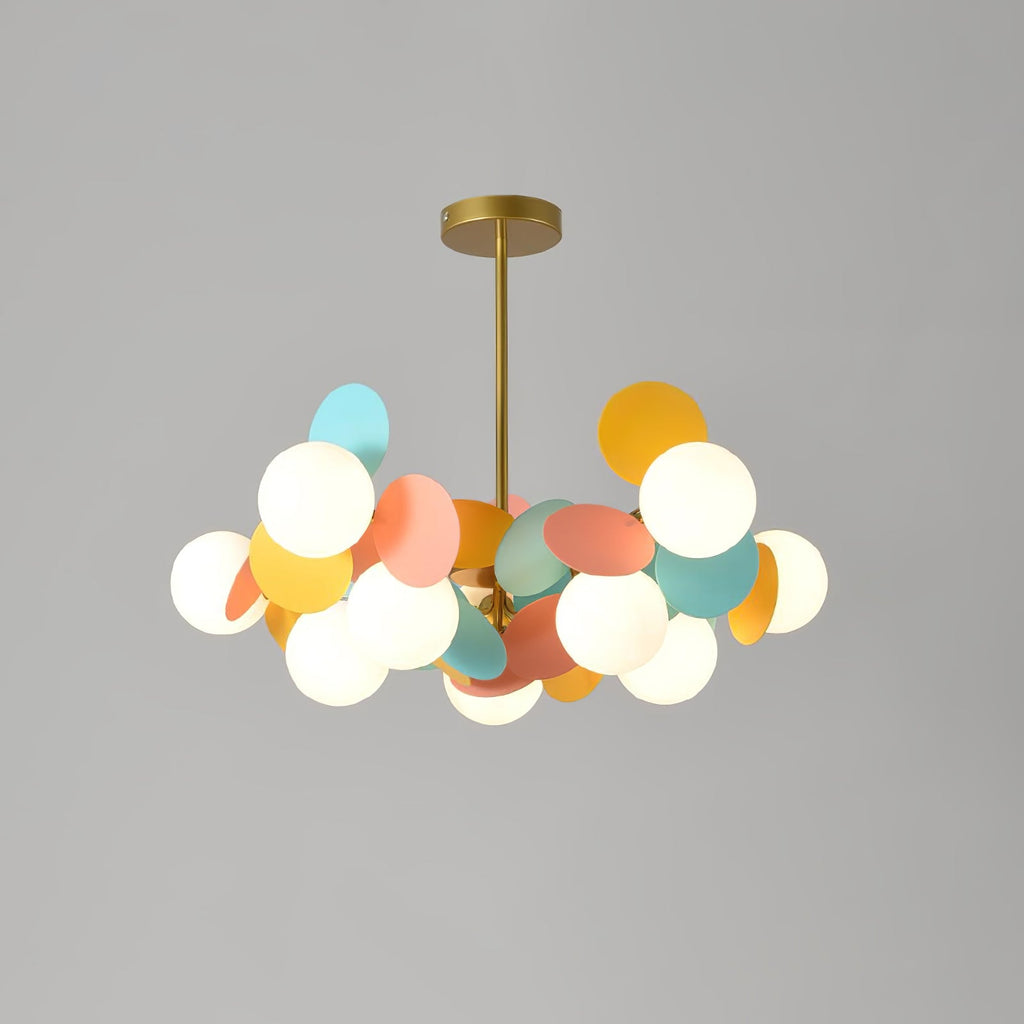 Tree chandelier lit against a neutral ceiling, warm light washing upward