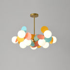 Tree chandelier lit against a neutral ceiling, warm light washing upward