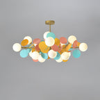 Branching gold chandelier arms holding open glass shades in close detail