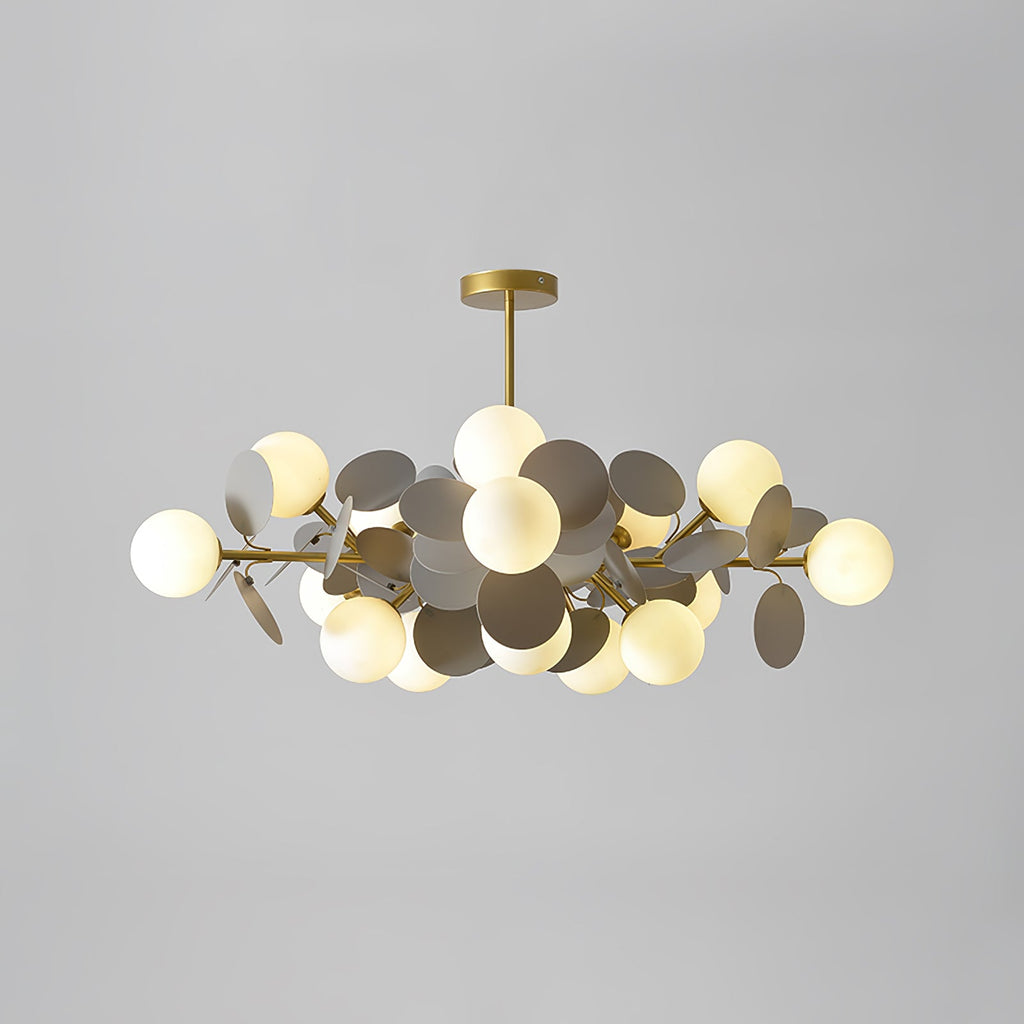 Tree chandelier with glass shades unlit, highlighting the botanical gold form