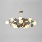 Tree chandelier with glass shades unlit, highlighting the botanical gold form