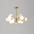 Tree chandelier suspended above a seating area, shades angled upward for ambient glow