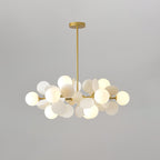 Detail of a single top-open glass shade seated in the gold branch arm
